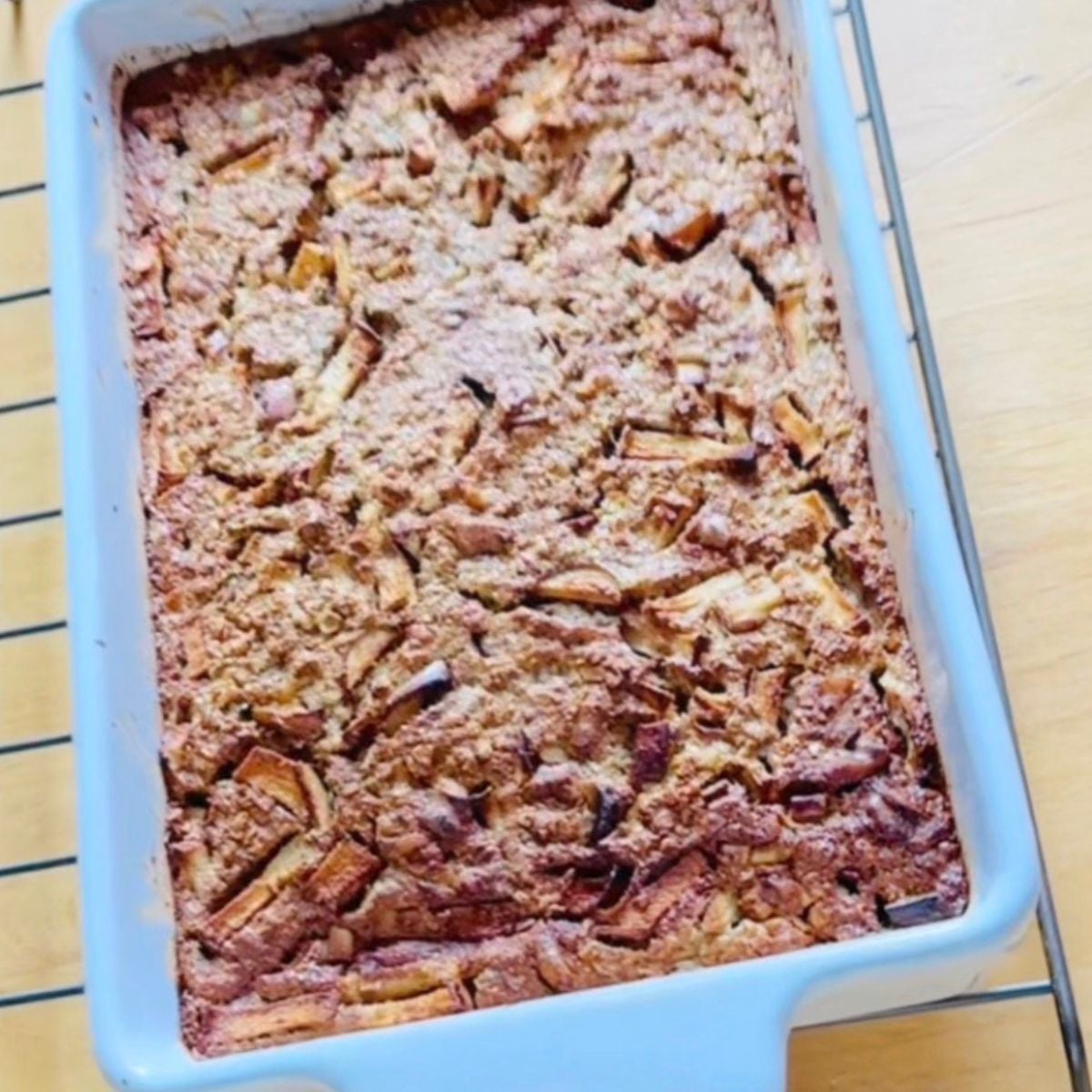 baking tray of apple cinnamon baked oatmeal placed on wire rack.