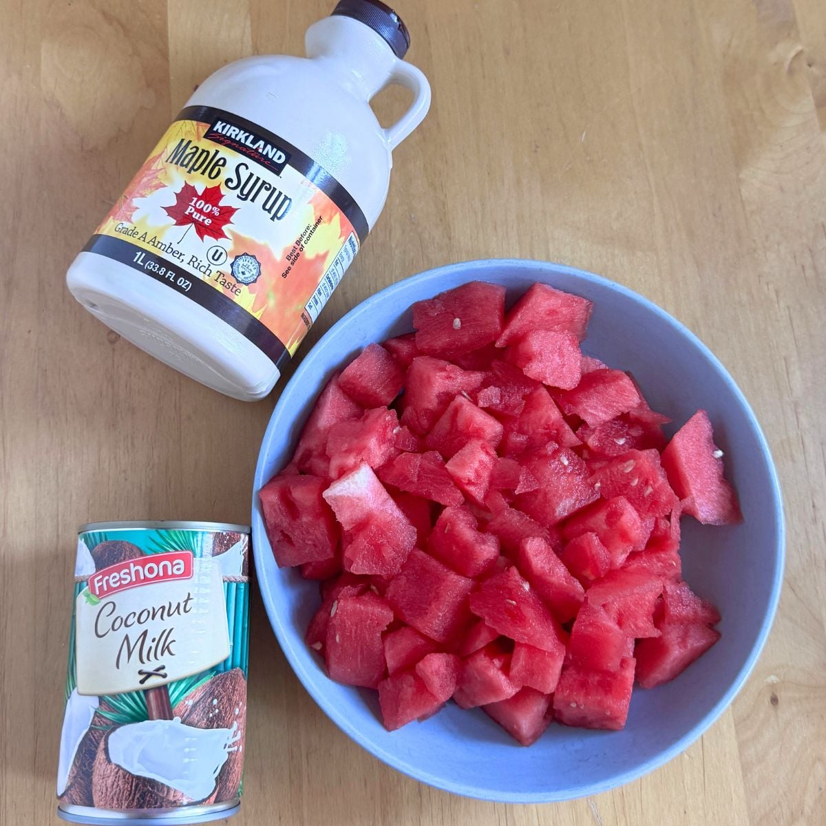 ingredients to make watermelon coconut milk cooler placed on marble.