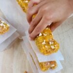 child holding no bake apricot oat bar.