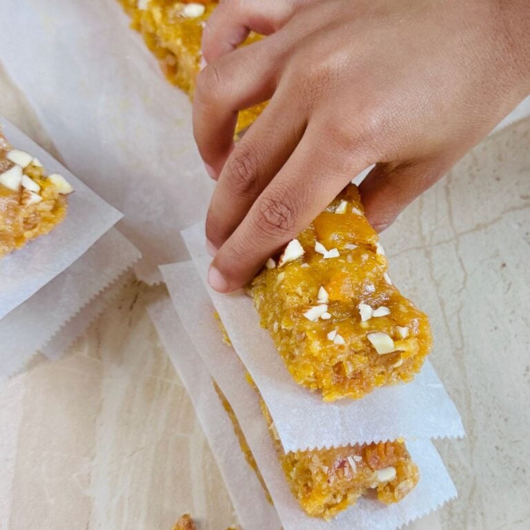 child holding no bake apricot oat bar.