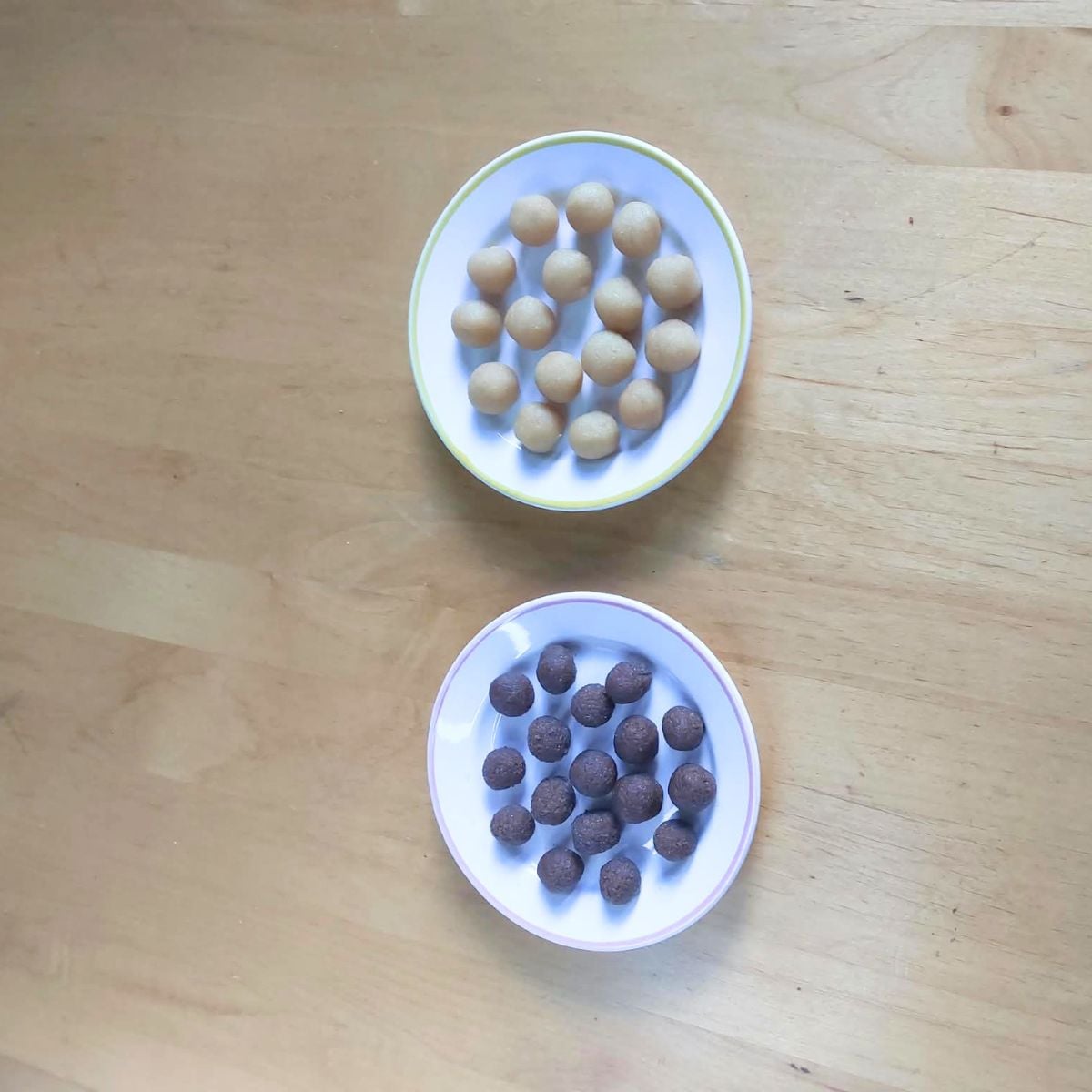 top view of vanilla and chocolate dough balls on different plates.