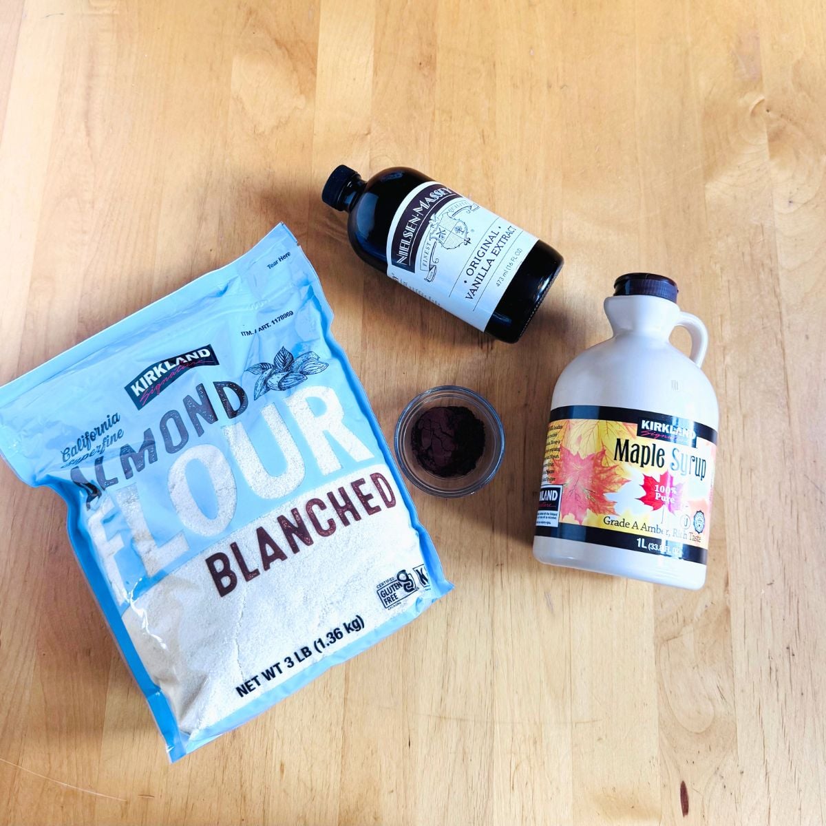 ingredients to make vanilla chocolate almond flour cookies on wooden table.