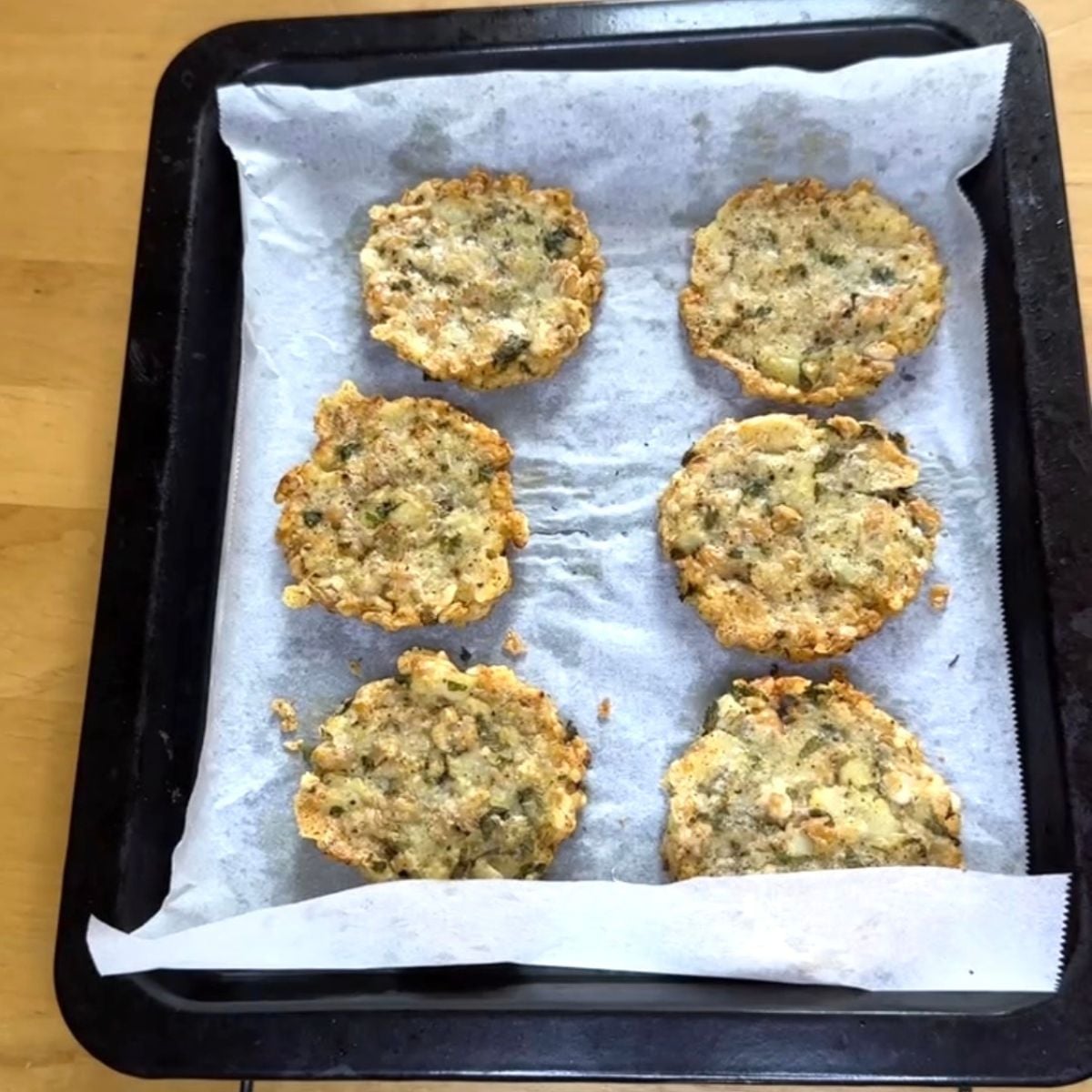 baked potato white bean cheese patties arranged on lined baking tray.