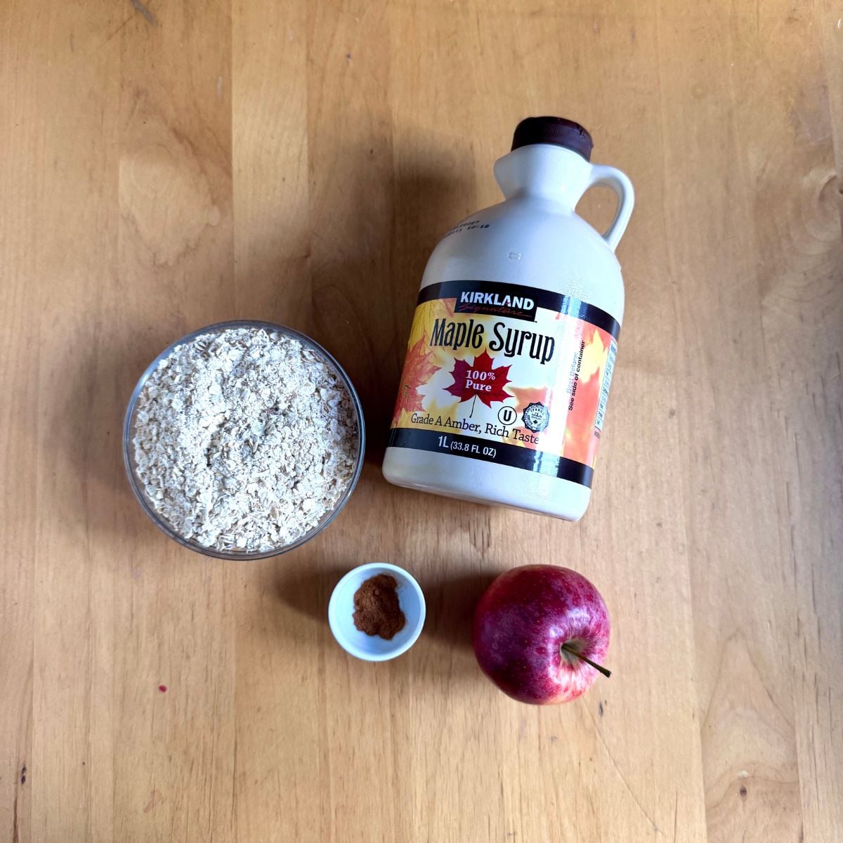ingredients to make apple oat bars on wooden table.