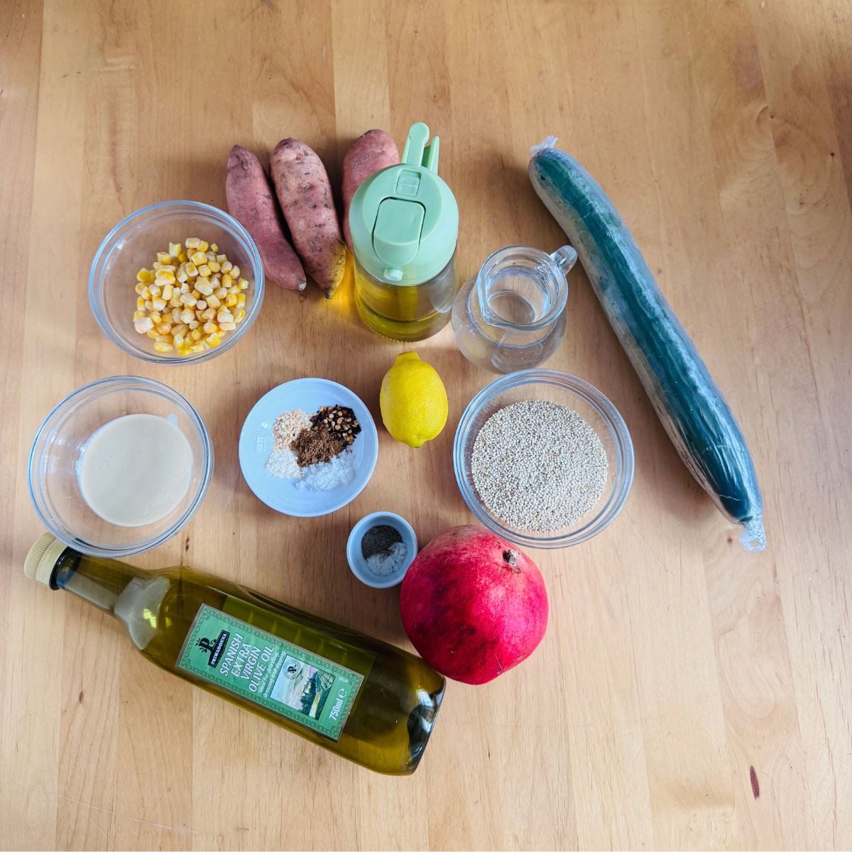 Ingredients to make sweet potato quinoa salad with tahini lemon dressing placed on wooden table.